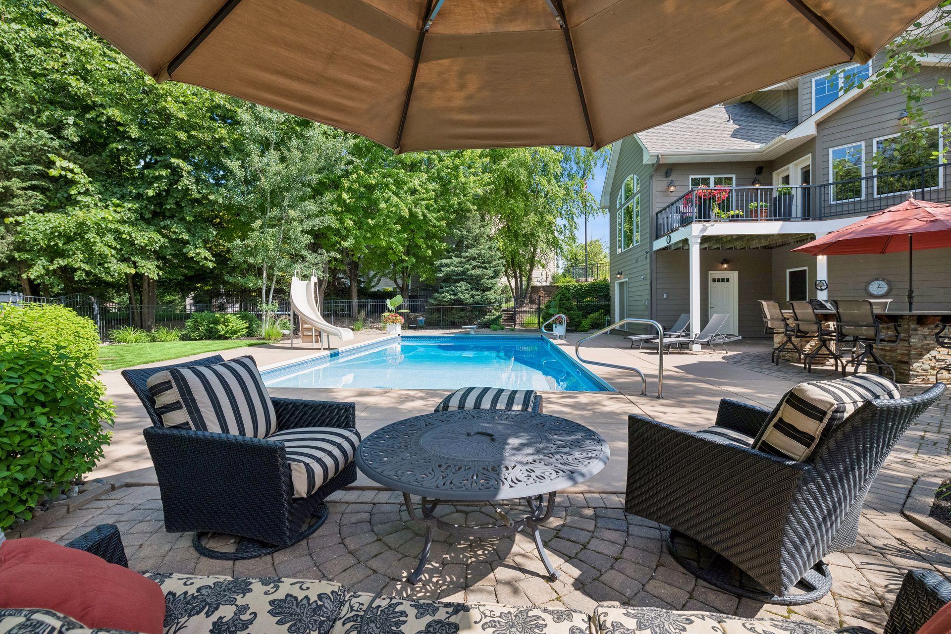 Grill station with pool side seating all surrounded by lush professional landscaping. Don't forget the outdoor shower at far end plus BONUS Private Pool Bath directly off pool decking for convenience w/2nd washer/dryer for pool towels.