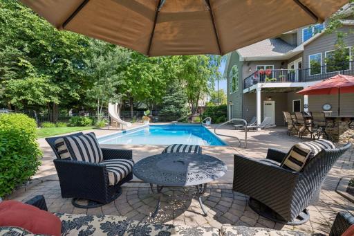 Shaded pool side seating all surrounded by lush professional landscaping. Don't forget the outdoor shower at far end plus BONUS Private Pool Bath directly off pool decking for convenience w/2nd washer/dryer for pool towels.