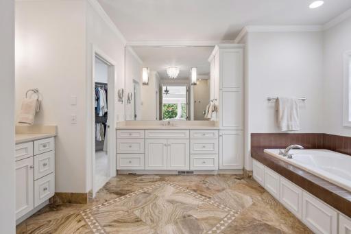 Main level primary suite bath with dual separate vanity areas, jetted tub, private stool and walk in shower. Don't forget the vacuum sweep for ease of sweeping is located under the vanity.