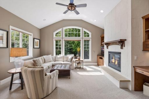 Cozy and comfortable hearth room with 2nd FP in home that is stone from floor to ceiling. Switch on wall opens up the pool cover from above for convenience. Lovely workstation for bills or paperwork is located on the right as well.