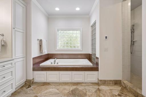 Separate tub and tile surround walk in shower along with heated floors which is such a joy to have!