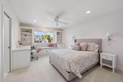 One of four upper bedrooms and this ONE is an ensuite! Charming bench to look out and read a book with custom built-ins and deck area.