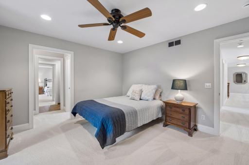 View toward upper hallway on the right and view towards bathroom pass-through and 4th upper bedroom on the left.