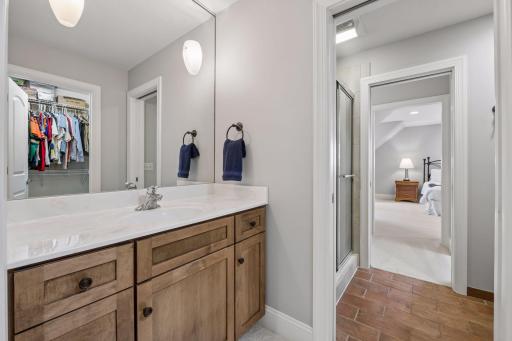 Each side has their own vanity and large walk-in closet to get ready set off by a pocket door for the shower and stool area.