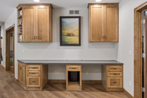 Need a space for home projects or additional study nooks? Well, here it is along with ample custom cabinetry and upper storage as well.