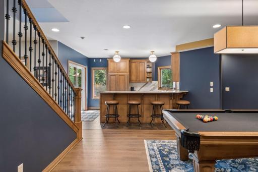 Can't wait for you to see and enjoy the lower level of this pristine home! Updated bar area with new countertops, beverage refrigerator, full size refrigerator and two windows to the pool outside!
