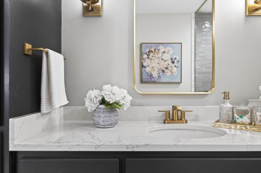 Elegant vanity vignette showcasing high-end finishes. Fully equipped with premium
brass fixtures, a brass mirror, brass lighting, a new high-powered fan, and all-new plumbing/electrical.