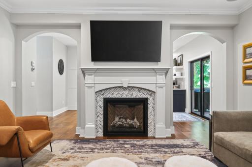 Statement fireplace surrounded by custom millwork.