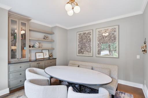 Elegant formal dining room features custom built-ins, sophisticated lighting, and refined finishes.