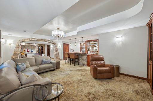 Expansive bar and seating area designed to accommodate large gatherings with easeâthis lower level has hosted events for 60+ guests. Rich finishes, statement lighting, and seamless flow create an unforgettable entertaining environment.