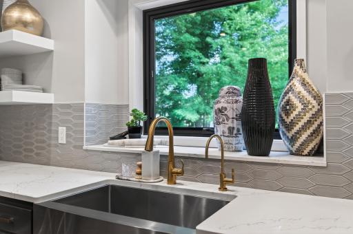 Enjoy serene wooded views from the oversized kitchen sink window.