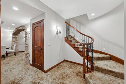 Gracious transition to the "Speak Easy" lower level. Highlighted by curved architectural detailing and refined finishes, setting the tone for the immersive, lounge-inspired experience that unfolds below.