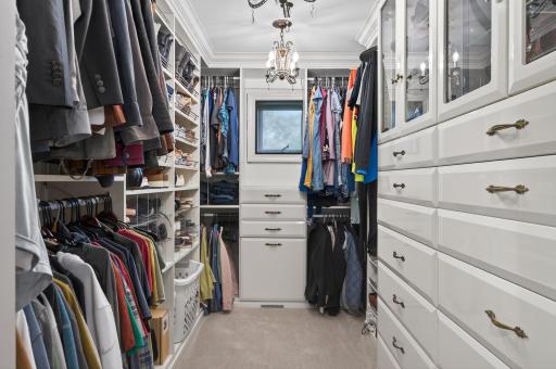 Exceptional custom walk-in closet with boutique-style organization, including built-in shelving, drawers, and dedicated hanging space.