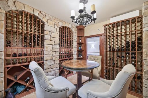 Surrounded by rich stonework and bespoke racking, this stunning space offers a true collectorâs showcaseâequally suited for intimate tastings or grand entertaining.