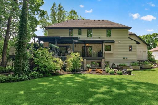 Stunning rear elevation overlooking lush, landscaped grounds that provide both privacy and a serene natural backdropâperfectly complementing the homeâs indoor-outdoor lifestyle.