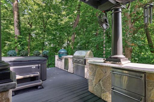 Extraordinary $150K outdoor gourmet kitchen featuring premium grilling stations, built-in refrigeration, and stone surroundâcrafted for both casual gatherings and elevated culinary experiences.