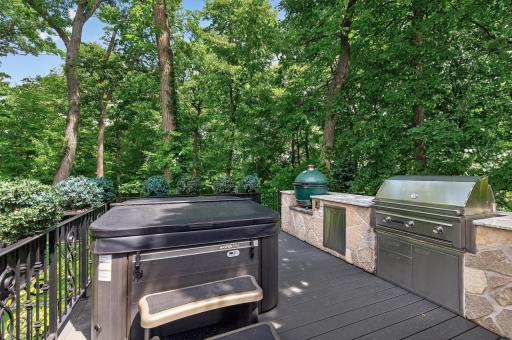 Multiple integrated grilling stations, including a Green Egg and flat-top grill, offer versatility for any chefâset within a beautifully designed stone and deck environment.