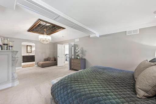 Primary suite features an Italian-inspired cove ceiling with chandelier.