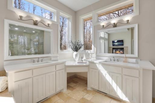 The primary bath, with large double vanities, also features a walk-in steam shower, perfect for destressing.