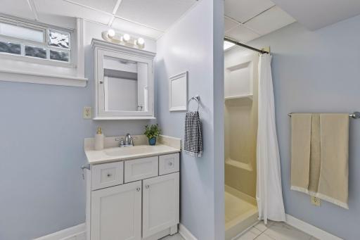 Conveniently located on the lower level, the updated Â¾ bathroom features a clean vanity, fresh finishes, and a walk-in shower, offering added comfort for guests or additional everyday convenience.