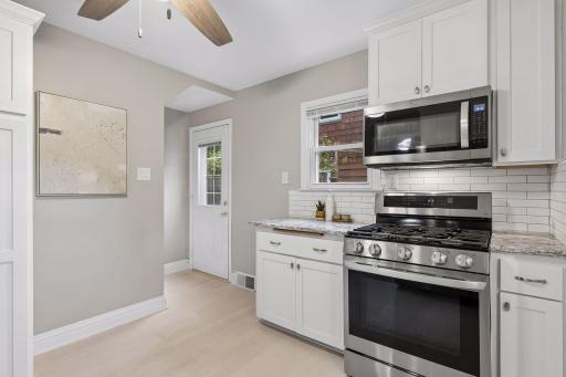 The kitchen offers direct access to the backyard patio, making indoor-outdoor entertaining effortless.