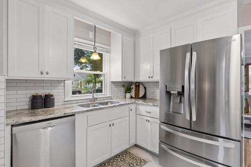 Wide countertops provide plenty of room for meal preparation while generous cabinetry keeps everything neatly organized.