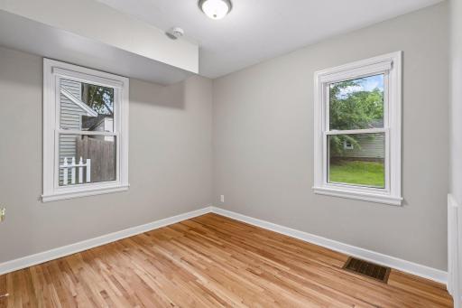 The two main-floor bedrooms offer comfortable living with beautiful natural light, hardwood floors, and convenient closet space in each room.