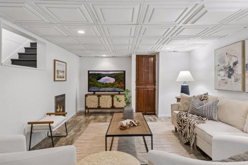The finished lower-level family room offers a comfortable retreat with recessed lighting, durable flooring, and plenty of space to gather.