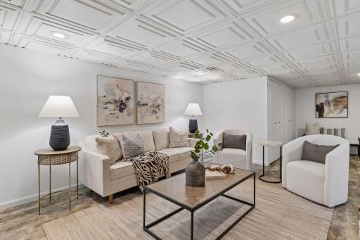 Continuing downstairs, you'll find another spacious view of the family room, providing flexible space for movie nights, game days, or everyday relaxation.