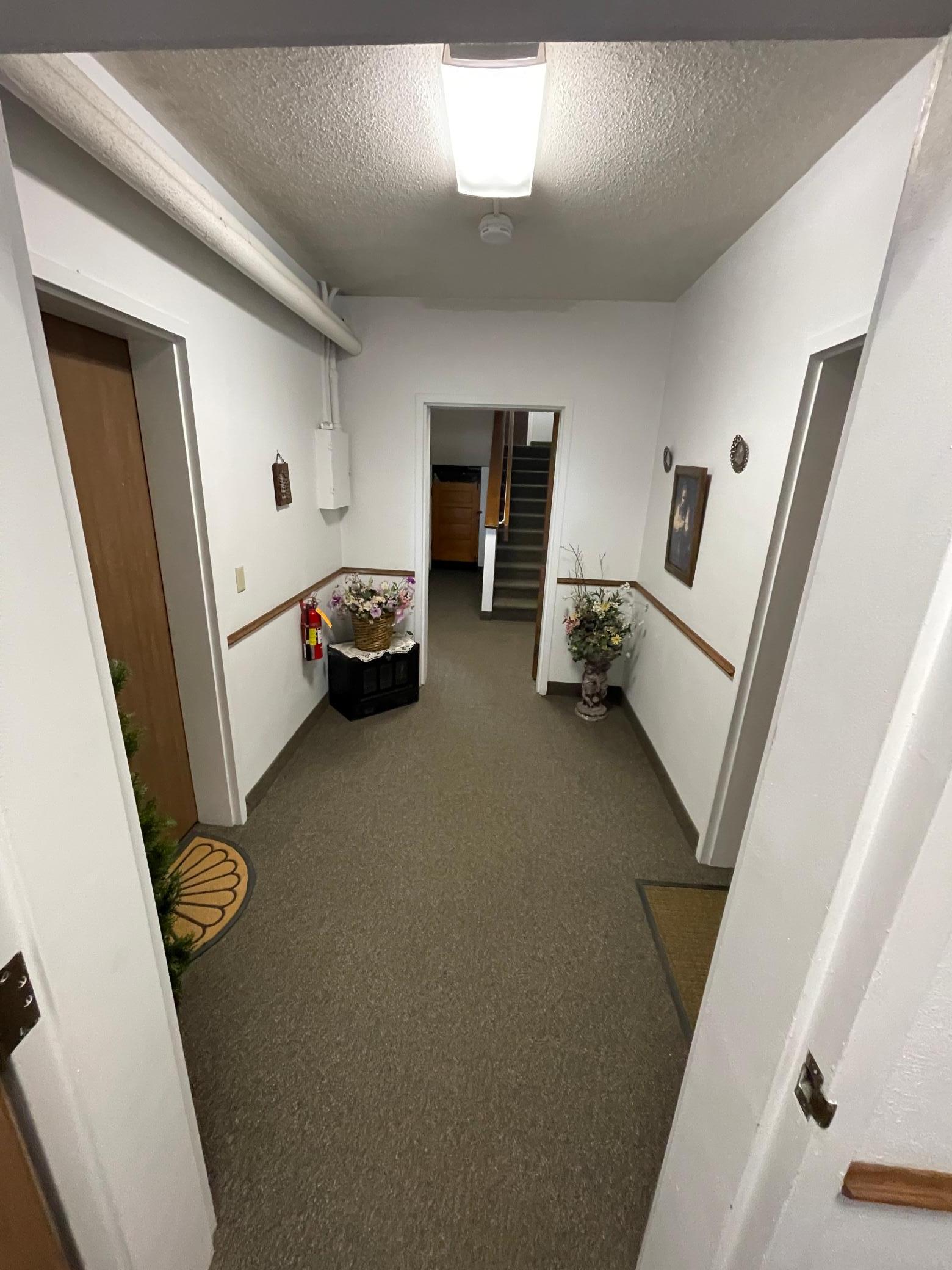 Hallway to laundry, storage and stairs to garage/extra storage!