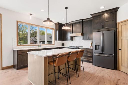 Qaurtz countertops, black stainless appliances.