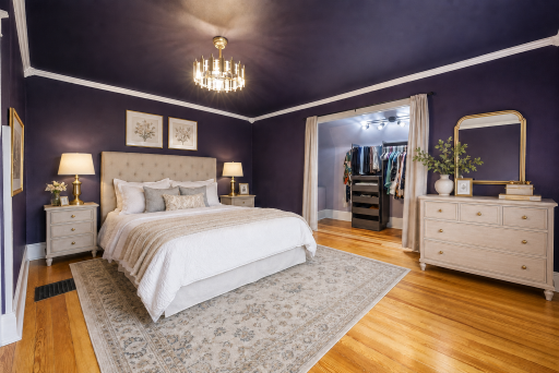 Virtually Staged Primary Bedroom with beautiful hardwood floors, crown molding and custom closet system