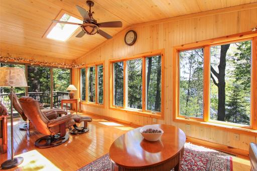 Sun porch surrounded with windows on three sides and two skylightrs above.