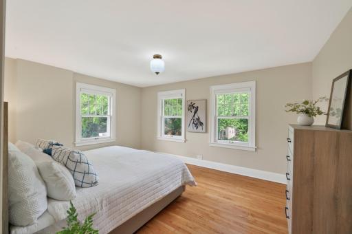 Bright bedroom with hardwood floors and multiple exposures.Bright third bedroom with hardwood floors and lots of natural light