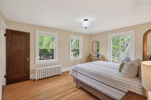 Spacious primary suite featuring hardwood floors and abundant natural light.