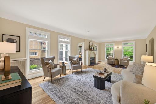 Elegant living room anchored by a striking fireplace and classic architectural details.