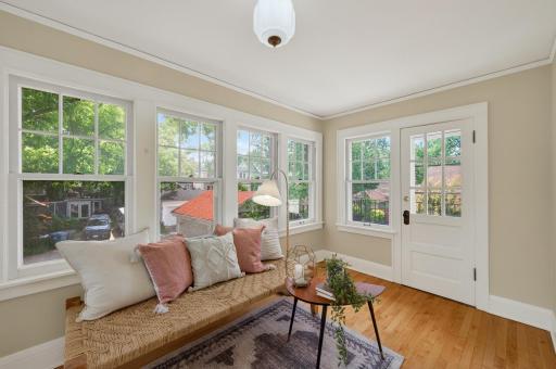 Charming sunroom retreat with access to a private Juliet balcony overlooking the surrounding neighborhood.