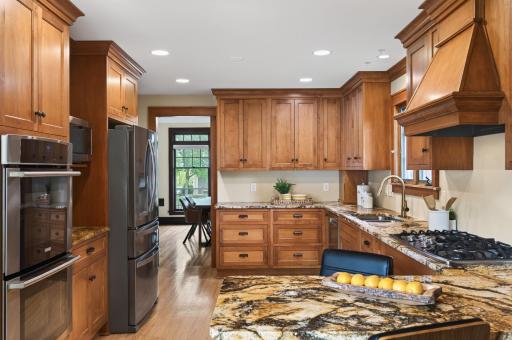Expansive workspace and abundant storage framed by rich wood craftsmanship.