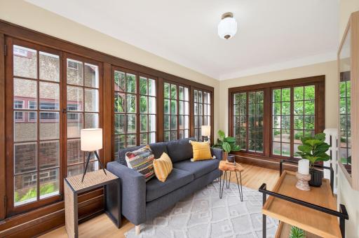 Stunning sunroom wrapped in windows and surrounded by lush views.