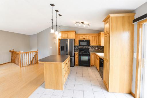 Hickory cabinets with roll outs, pantry & tile backsplash.