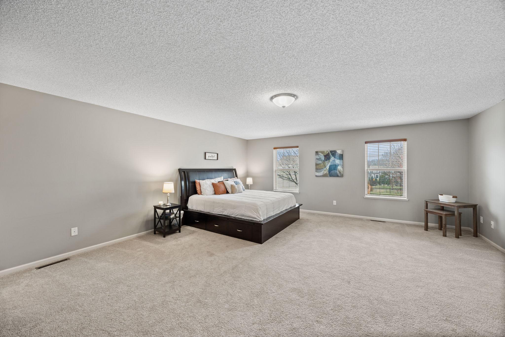 The primary suite offers a spacious retreat with a sizable walk-in closet.
