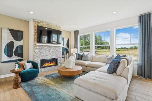 (Photo of model home, finishes will vary) A wall of large windows in the Great Room offer a sunlit view of the neighborhood and brighten daytime gatherings. It’s an ideal space for relaxing and enjoying the company of loved ones.