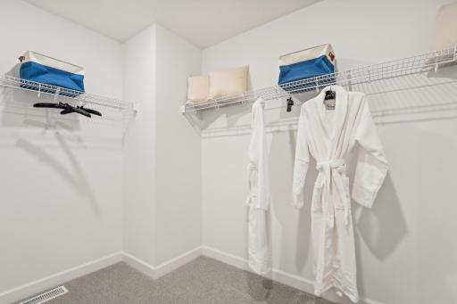 (Photo of model home, finishes will vary) The walk-in closet is easily accessible through the bathroom