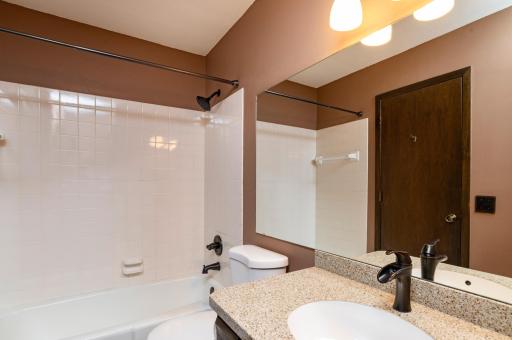 Main level full bath with new toilet, counter top and fixtures.