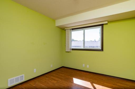 Bedroom 2 with lots of light and laminate flooring.