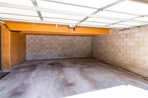 Large double garage with automatic garage door openers and outside remote pad.