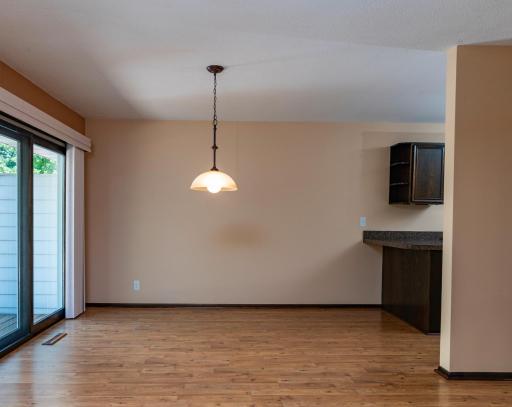 Dining area with access to kitchen. A spacious breakfast/serving bar separates dining and kitchen spaces.