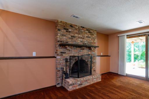 Lower level family room has a slider door leading to the ground level patio.