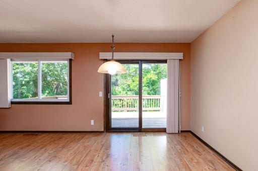 Dining area with access to kitchen and patio doors to oversize deck.