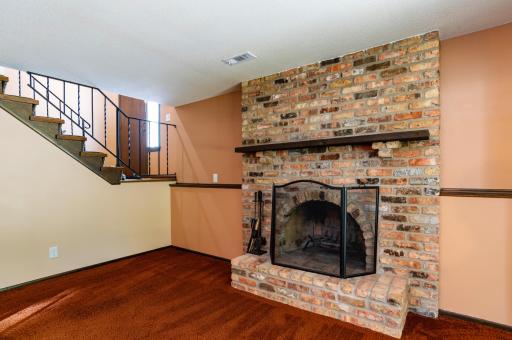 The lower level family room features an old Chicago brick wood burning fireplace.